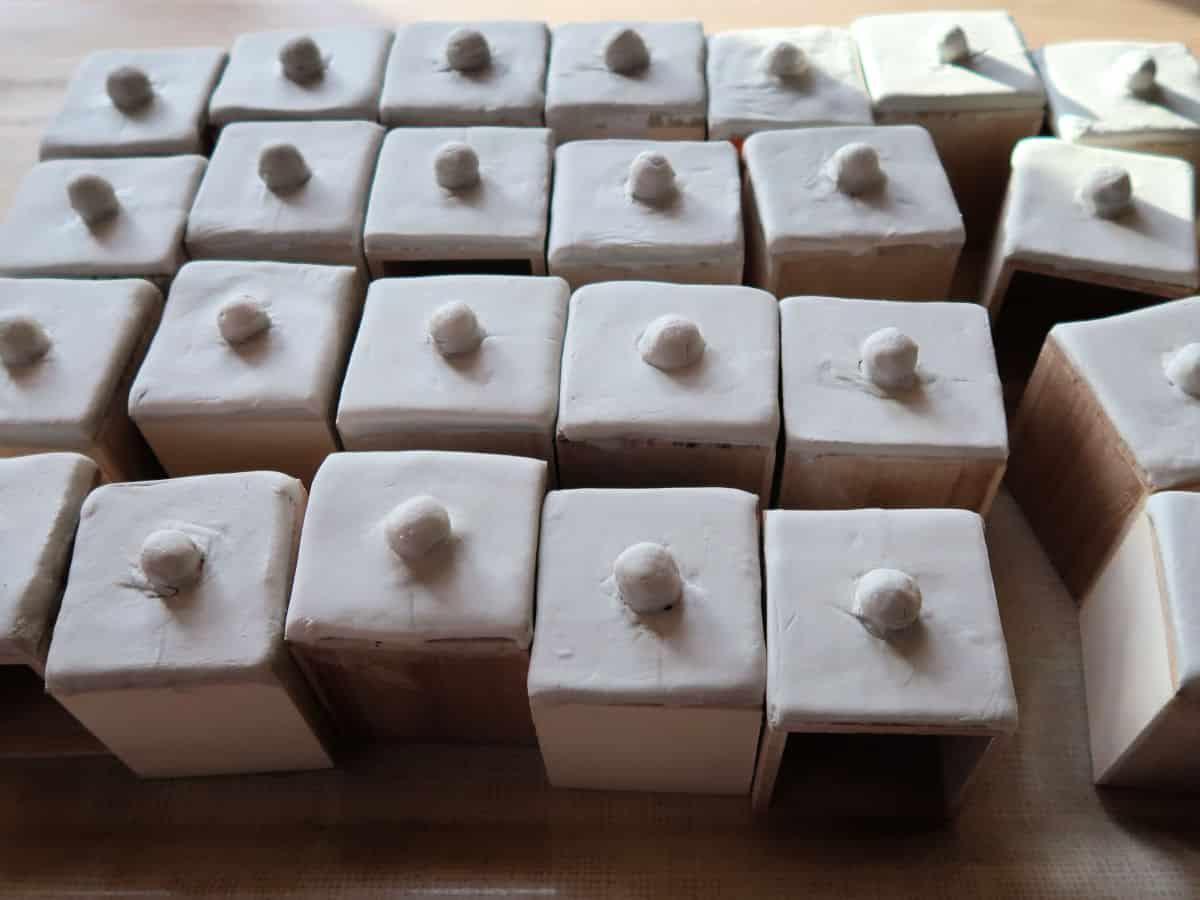 DIY Spice Chest made from an advent calendar box and air-dried clay. This easy craft tutorial turns a plain wooden advent calendar box into a gorgeous spice chest with clay fronted drawers decorated with acrylic paints. Perfect for holding spices or little knick-knacks.